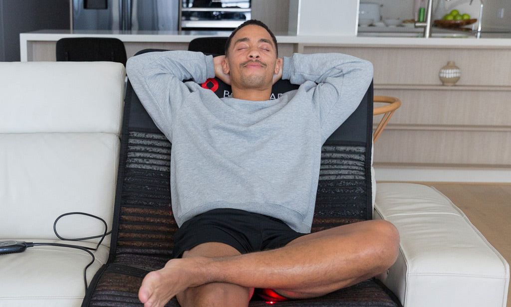 Man Lounging On PEMF Mat On Sofa