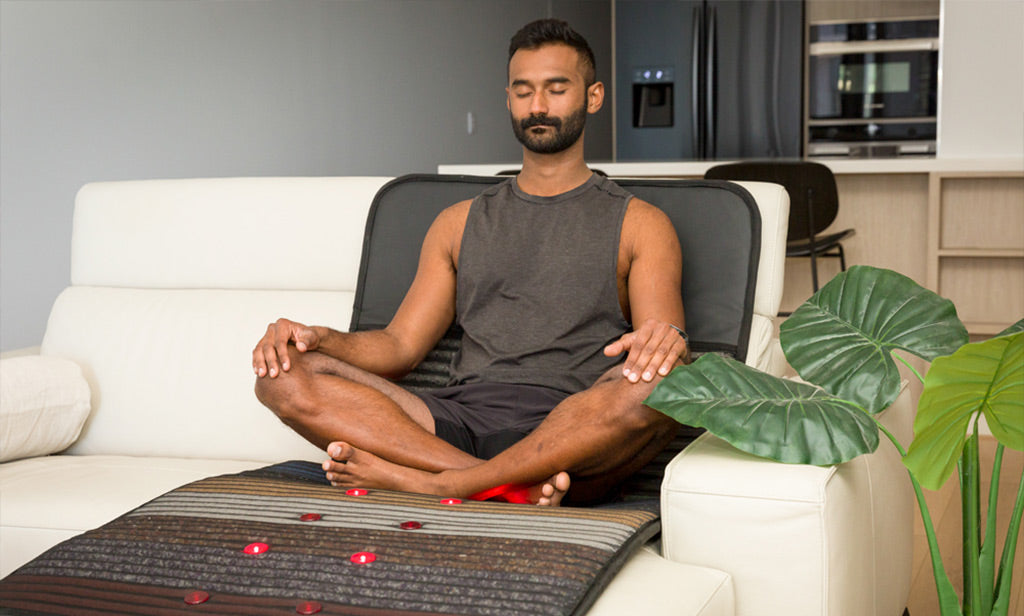 Man Sitting On Infrared PEMF Mat Max