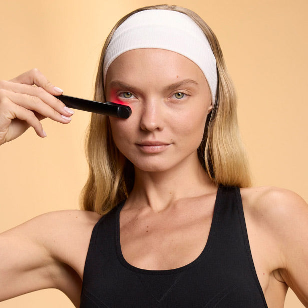 Woman Using Red Light Face Wand